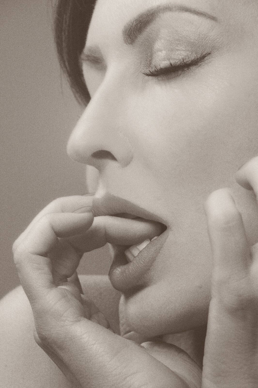 A softly lit, warm-toned intimate portrait