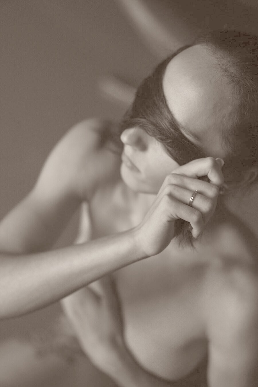 A softly lit, intimate black-and-white portrait